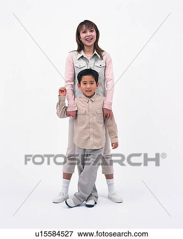 Stock Photo - A woman and her son posing in front of camera. Fotosearch