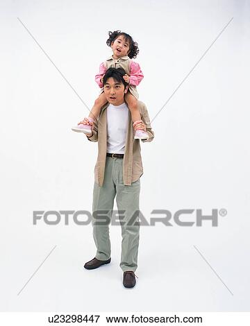 Stock Photo - Father carrying a daughter on his shoulders. Fotosearch