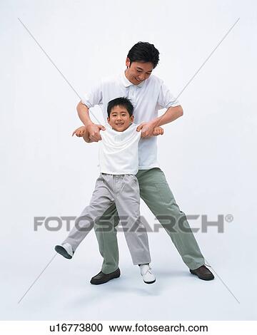 Stock Image - Front view of a man lifting his son. Fotosearch