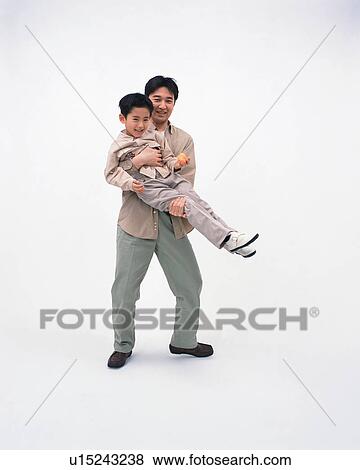 Stock Photo - Front view of a man lifting up his son. Fotosearch