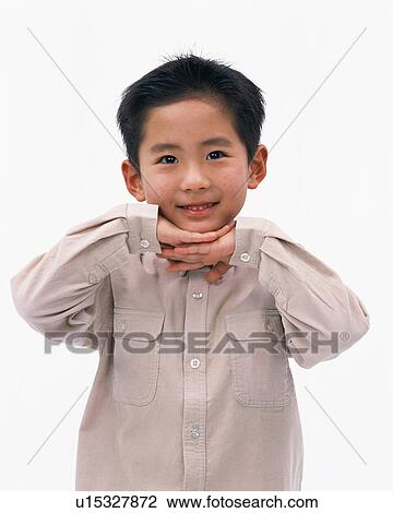 Front view of a small boy placing his hands under his chin View Large Photo Image Stock Image - Front view of a small boy placing his hands under his chin. Fotosearch