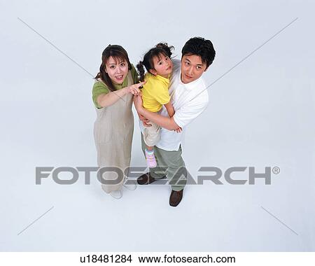 Picture - High angle view of a couple along with their daughter. Fotosearch
