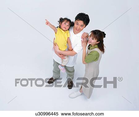 Stock Photography - High angle view of a couple along with their daughter. Fotosearch