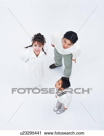 High angle view of a couple staring at one direction along with their son View Large Photo Image Stock Image - High angle view of a couple staring at one direction along with their son. Fotosearch