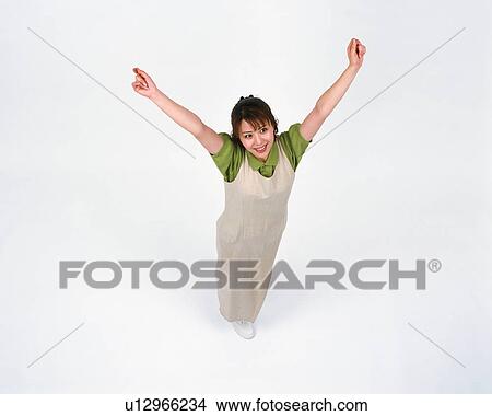 Picture - High angle view of a woman with her hands raised. Fotosearch