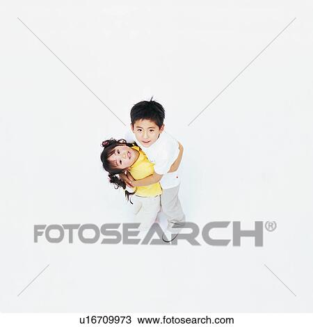 High angle view of two children hugging each other View Large Photo Image Stock Image - High angle view of two children hugging each other. Fotosearch