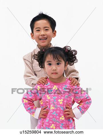 Picture - Portrait of a small girl with her brother. Fotosearch