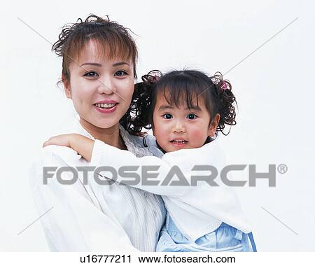 Stock Image - Portrait of a woman holding her daughter. Fotosearch