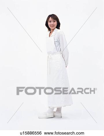 Stock Photograph - Side view of a pretty woman wearing an apron. Fotosearch