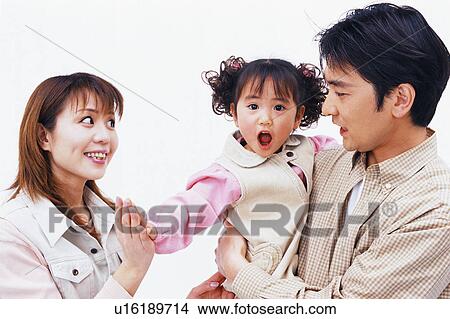 Picture - Side view of a small girl giving high-five to her mother. Fotosearch