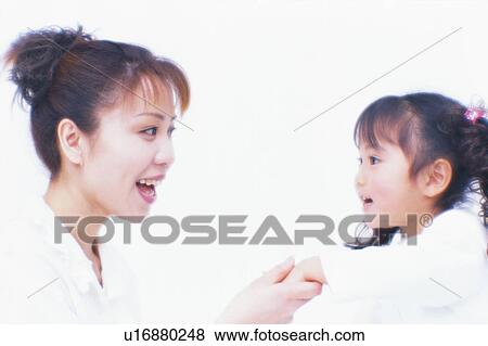 Side view of a woman holding her daughter's hand View Large Photo Image Stock Photo - Side view of a woman holding her daughter's hand. Fotosearch