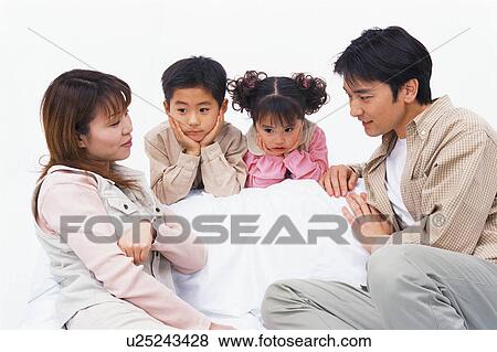 Stock Photo - Two kids in deep thoughts and watched over by their parents. Fotosearch