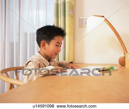 A boy doing his homework View Large Photo Image Stock Photo - A boy doing his homework. Fotosearch