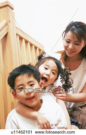 A boy with his sister and mother looking at camera View Large Photo Image Stock Image - A boy with his sister and mother looking at camera. Fotosearch