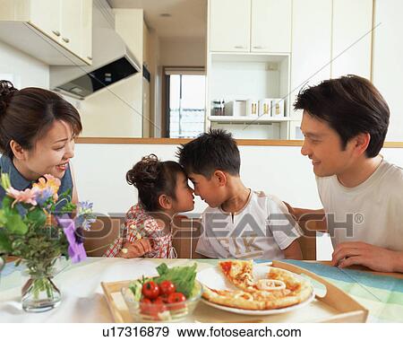 Stock Photo - A brother and a sister having an eye contact while their parents look on. Fotosearch