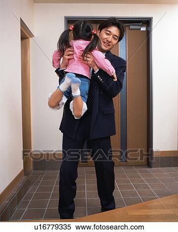 Stock Photography - A father lifting his daughter up. Fotosearch