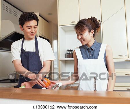 A husband helping his wife in kitchen View Large Photo Image Stock Image - A husband helping his wife in kitchen. Fotosearch