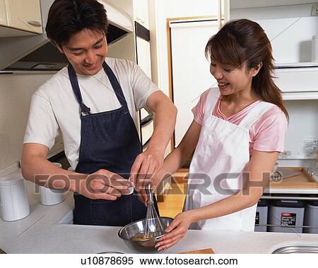A husband helping his wife in kitchen View Large Photo Image Stock Photography - A husband helping his wife in kitchen. Fotosearch
