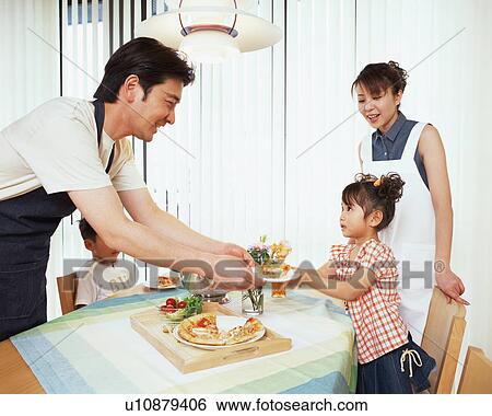 A man serving pizza to his daughter View Large Photo Image Stock Photograph - A man serving pizza to his daughter. Fotosearch