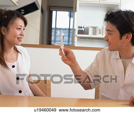 A man taking a picture of his wife with mobile phone View Large Photo Image Stock Photo - A man taking a picture of his wife with mobile phone. Fotosearch