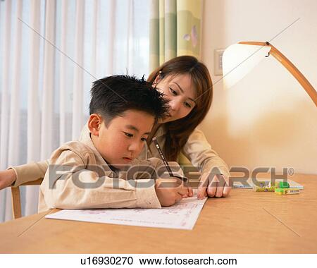 A mother helping her son do homework View Large Photo Image Stock Image - A mother helping her son do homework. Fotosearch