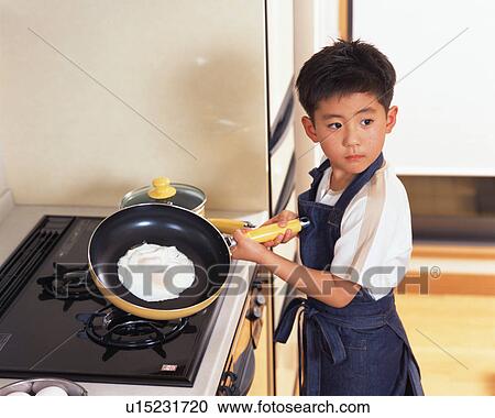 A small boy cooking View Large Photo Image Stock Image - A small boy cooking. Fotosearch