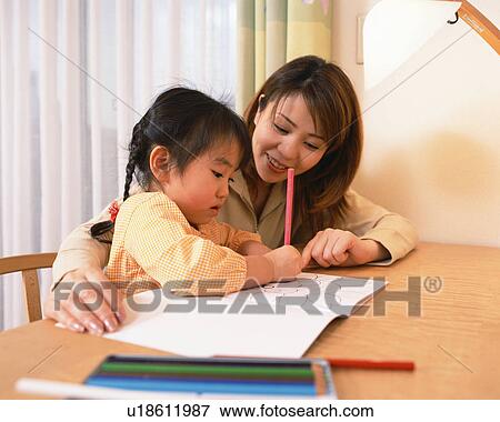 Stock Photo - A small girl coloring with her mother. Fotosearch