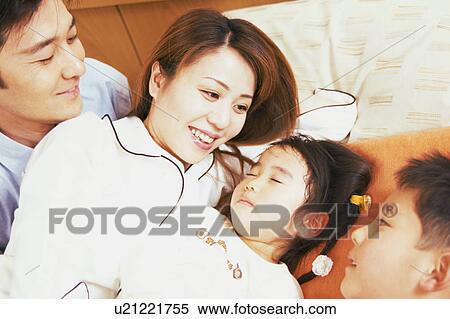 A small girl taking a nap beside her mother View Large Photo Image Stock Photography - A small girl taking a nap beside her mother. Fotosearch