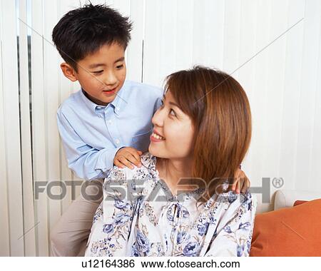 A woman and a small boy making eye contact View Large Photo Image Stock Photograph - A woman and a small boy making eye contact. Fotosearch