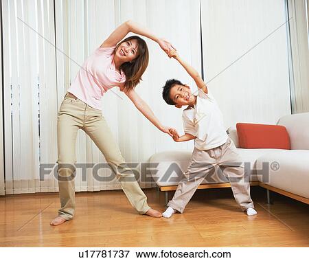 A woman stretching with her son View Large Photo Image Stock Photo - A woman stretching with her son. Fotosearch