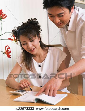 Husband helping his wife to checking household account View Large Photo Image Stock Image - Husband helping his wife to checking household account. Fotosearch
