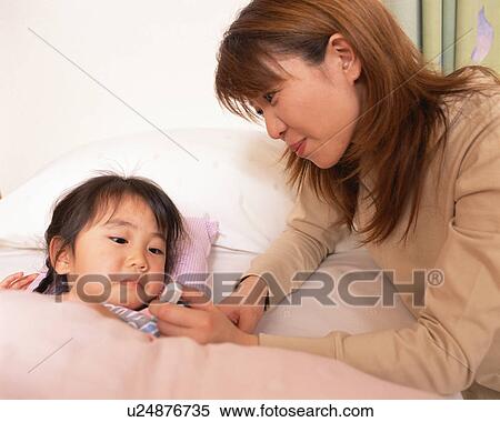 Mother checking temperature of her daughter View Large Photo Image Stock Photography - Mother checking temperature of her daughter. Fotosearch