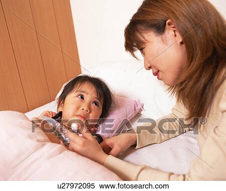 Mother checking temperature of her daughter View Large Photo Image Stock Photography - Mother checking temperature of her daughter. Fotosearch