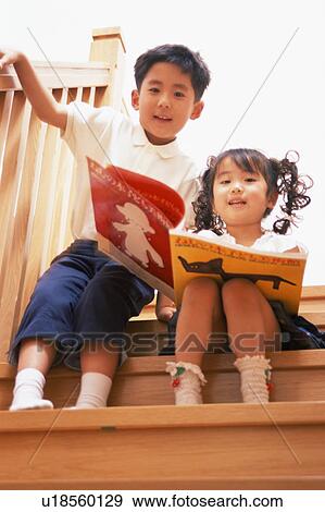 Stock Photo - Two children reading a book. Fotosearch