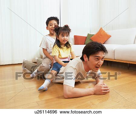 Two children sitting on their father's back View Large Photo Image Stock Photograph - Two children sitting on their father's back. Fotosearch