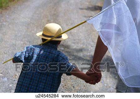 Picture - A boy walking with butterfly net. Fotosearch