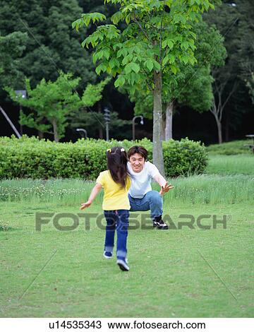 A girl running up to his father View Large Photo Image Stock Image - A girl running up to his father. Fotosearch