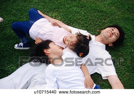 Family playing at a park View Large Photo Image Stock Image - Family playing at a park. Fotosearch