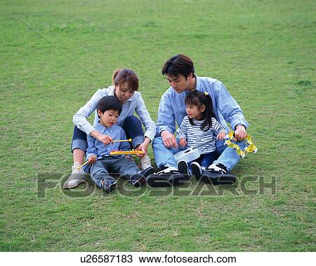 Family playing in a park View Large Photo Image Stock Image - Family playing in a park. Fotosearch