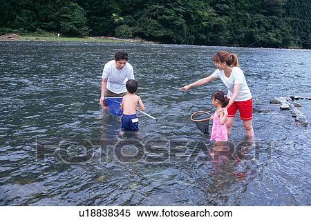 Family playing in river View Large Photo Image Stock Photography - Family playing in river. Fotosearch