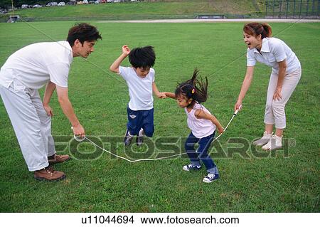 Picture - Family playing with jump rope. Fotosearch