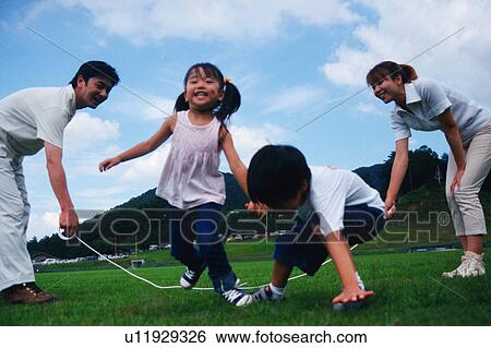 Stock Photograph - Family playing with jump rope. Fotosearch