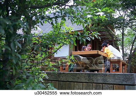 Family sitting outside of log cabin View Large Photo Image Stock Photography - Family sitting outside of log cabin. Fotosearch