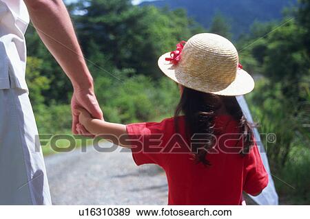 Stock Photo - Father and a daughter walking with butterfly net. Fotosearch