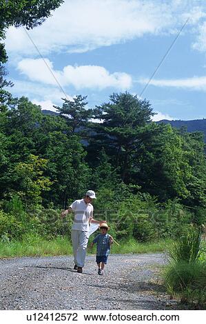 Father and a son walking with butterfly net View Large Photo Image Stock Image - Father and a son walking with butterfly net. Fotosearch