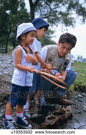 Stock Image - Father and children catching fishes. Fotosearch