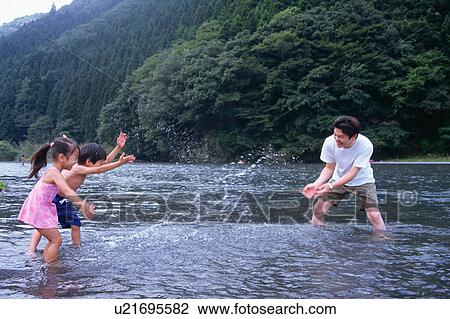 Father and children playing in river View Large Photo Image Stock Image - Father and children playing in river. Fotosearch