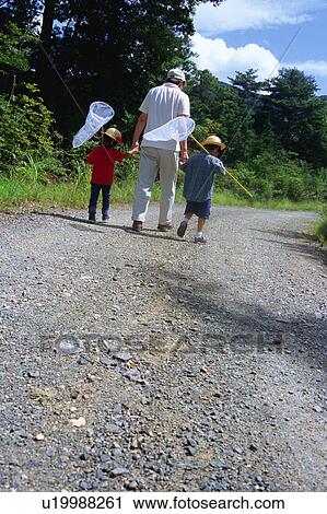 Father and children walking with butterfly net View Large Photo Image Stock Image - Father and children walking with butterfly net. Fotosearch