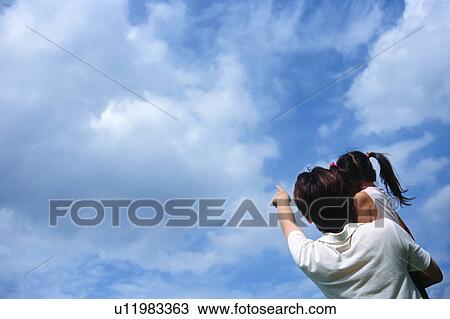 Stock Image - Father carrying his daughter. Fotosearch
