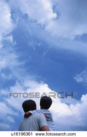Stock Image - Father carrying his son. Fotosearch